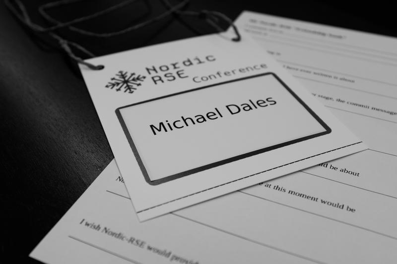 A photo of a name-badge saying "Nordic RSE Conference" and "Michael Dales"